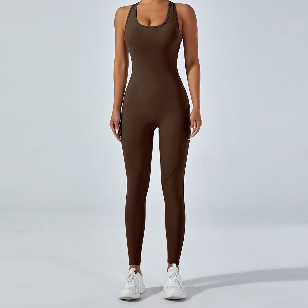 Person wearing a brown jumpsuit on a light gray background