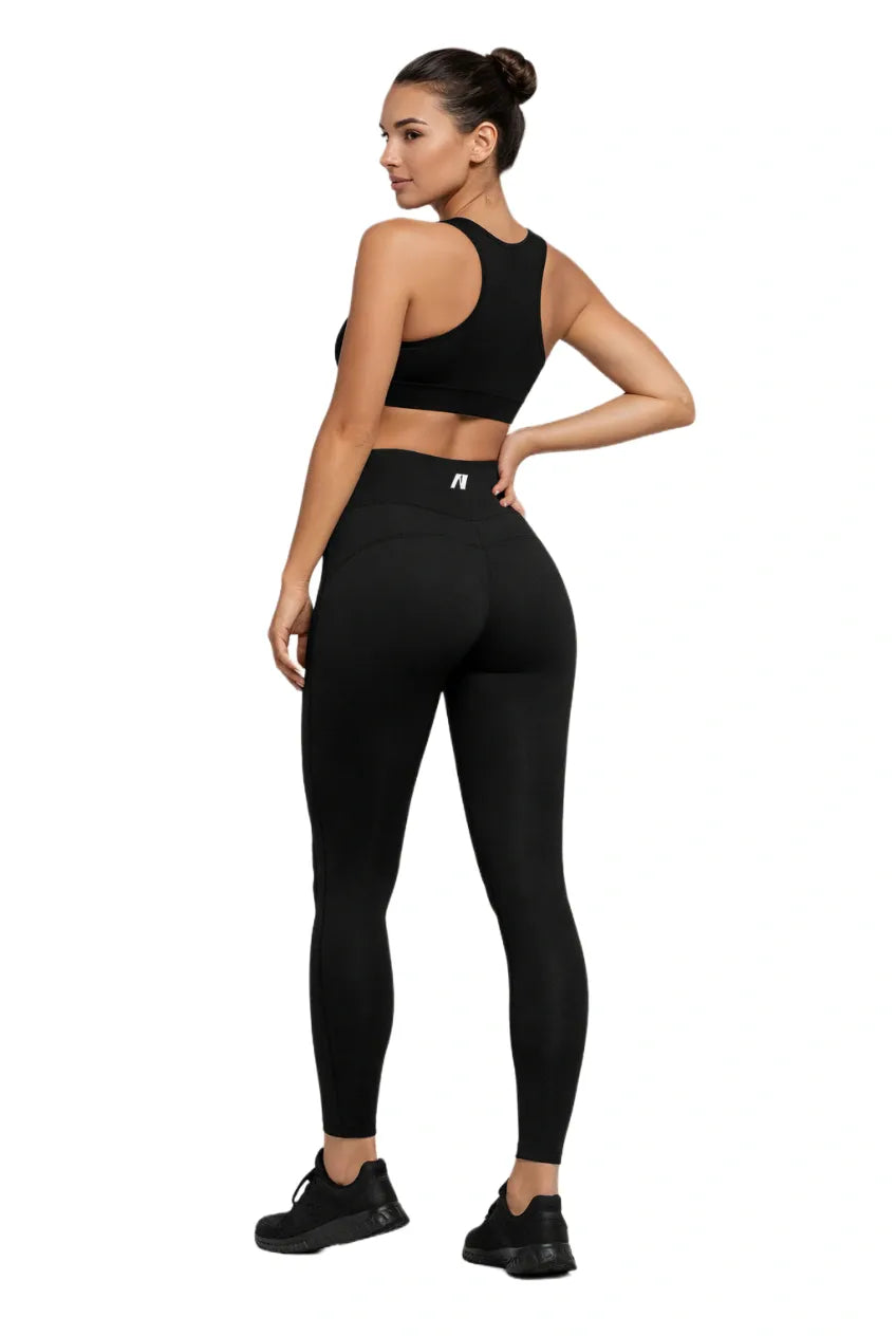 Woman wearing black leggings and a black top